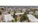Aerial view featuring community buildings, pool, picnic area, and mature trees at 2281 Vaughn # 104A, Aurora, CO 80014
