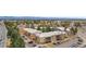 Aerial view showcases community buildings, mature trees, and ample parking at 2281 Vaughn # 104A, Aurora, CO 80014