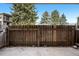 Private patio area with a wooden fence, perfect for outdoor relaxing at 2281 Vaughn # 104A, Aurora, CO 80014