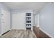 Bright bedroom with closet, built-in shelving, and a view into the hall at 2281 Vaughn # 104A, Aurora, CO 80014