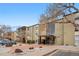 Multi-story building with covered entryway, well-maintained landscaping, and parking at 2281 Vaughn # 104A, Aurora, CO 80014