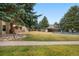 Community grounds with mature trees, picnic shelter, pool, and walking path at 2281 Vaughn # 104A, Aurora, CO 80014