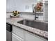 Close up on stainless steel kitchen sink with granite countertops and white cabinets at 2281 Vaughn # 104A, Aurora, CO 80014