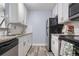Updated kitchen with white cabinets, granite countertops, stainless steel appliances, and tile backsplash at 2281 Vaughn # 104A, Aurora, CO 80014