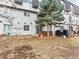 Townhome backyard with concrete patio, privacy fence, BBQ grill, and a mature pine tree at 421 E Highline Cir, Centennial, CO 80122