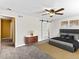 This bedroom features a ceiling fan, barn door to ensuite, and neutral decor with a mid-century modern dresser at 421 E Highline Cir, Centennial, CO 80122