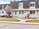Cozy townhomes featuring stucco exterior with grey roof, walkway, and quaint lawns in a well-maintained community at 421 E Highline Cir, Centennial, CO 80122