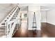 Inviting foyer with hardwood floors and a staircase leading to the upper level and an open view to the backyard at 421 E Highline Cir, Centennial, CO 80122