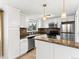 Beautiful kitchen featuring white cabinets, stainless steel appliances, and tile backsplash for a modern touch at 421 E Highline Cir, Centennial, CO 80122