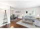 Inviting living room featuring hardwood floors, modern gray sofa, neutral paint, and a bright and airy ambiance at 421 E Highline Cir, Centennial, CO 80122