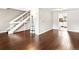 Open floor plan with gleaming hardwood floors, white railing staircase and neutral paint offers bright and airy ambiance at 421 E Highline Cir, Centennial, CO 80122