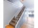 Carpeted staircase features white banister and leads to wood floors with sliding door access to the backyard at 421 E Highline Cir, Centennial, CO 80122