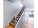 Carpeted staircase leading to a bright living space with wood floors at 421 E Highline Cir, Centennial, CO 80122