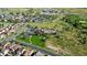 A captivating aerial view of a planned community featuring a pool, clubhouse, and sidewalks at 22475 E Hidden Trail Dr, Parker, CO 80138