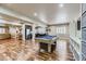 Large open basement featuring a billiards table, wet bar, and hardwood floors at 22475 E Hidden Trail Dr, Parker, CO 80138
