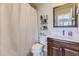 Bathroom featuring a shower with a shower curtain, bright mirror, and dark stained vanity at 22475 E Hidden Trail Dr, Parker, CO 80138