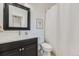 Bathroom featuring a shower with a shower curtain, bright mirror, and dark stained vanity at 22475 E Hidden Trail Dr, Parker, CO 80138
