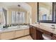 Elegant bathroom with a soaking tub, granite counters, decorative chandelier, and white plantation shutters at 22475 E Hidden Trail Dr, Parker, CO 80138