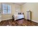 Cozy bedroom with wood floors, bright window with plantation shutters, and neutral paint at 22475 E Hidden Trail Dr, Parker, CO 80138