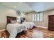 Comfortable bedroom featuring hardwood floors, recessed lighting, and a pair of twin beds at 22475 E Hidden Trail Dr, Parker, CO 80138