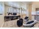 Spacious bonus room with custom gaming area, cozy chairs, and natural light from shuttered windows at 22475 E Hidden Trail Dr, Parker, CO 80138