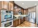Modern kitchen with stainless steel appliances and beautiful wood cabinets at 22475 E Hidden Trail Dr, Parker, CO 80138