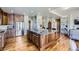 Spacious kitchen featuring a large island, stainless steel appliances, and hardwood floors at 22475 E Hidden Trail Dr, Parker, CO 80138
