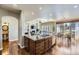 Well-lit kitchen island with granite countertops and views of the dining and living areas at 22475 E Hidden Trail Dr, Parker, CO 80138