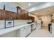Bright laundry room with plenty of counter space, storage cabinets, and modern appliances at 22475 E Hidden Trail Dr, Parker, CO 80138
