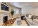 Cozy living room features a fireplace, hardwood floors, and comfortable seating area with natural light at 22475 E Hidden Trail Dr, Parker, CO 80138