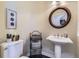 Powder room featuring a pedestal sink, decorative mirror, and neutral walls at 22475 E Hidden Trail Dr, Parker, CO 80138