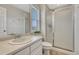 Bright bathroom featuring a glass enclosed shower, white cabinets, and tile flooring at 2618 Bellavista St, Castle Rock, CO 80109