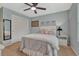 Comfortable bedroom with light blue walls, a ceiling fan, and ample closet space at 2618 Bellavista St, Castle Rock, CO 80109