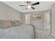 Cozy bedroom features neutral walls, patterned bedding, and a view to an ensuite bathroom at 2618 Bellavista St, Castle Rock, CO 80109