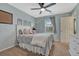 Charming bedroom with light blue walls, a ceiling fan, and a cozy bed with decorative pillows at 2618 Bellavista St, Castle Rock, CO 80109