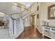 Grand foyer featuring a curved staircase, hardwood floors, and soaring ceilings at 2618 Bellavista St, Castle Rock, CO 80109
