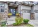 Elegant front entry with double doors, stone accents, and manicured landscaping at 2618 Bellavista St, Castle Rock, CO 80109
