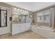 Relaxing main bathroom with a soaking tub, granite countertop, and ample cabinet space at 2618 Bellavista St, Castle Rock, CO 80109