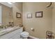Compact powder room featuring granite countertop and decorative accents at 2618 Bellavista St, Castle Rock, CO 80109
