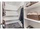 Walk-in closet with built-in shelving, providing ample storage space for clothes and accessories at 6680 E Mississippi Ave # 3, Denver, CO 80224