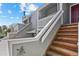 Close up exterior shot of the stairs leading to a two-story townhouse featuring a cozy, covered balcony at 6680 E Mississippi Ave # 3, Denver, CO 80224