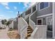 Two-story townhouse featuring wooden stairs, covered balcony, and a charming exterior at 6680 E Mississippi Ave # 3, Denver, CO 80224