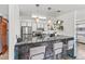 Kitchen showcasing stone counter with barstool seating, stainless appliances, and hanging decorative plants at 6680 E Mississippi Ave # 3, Denver, CO 80224