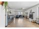 Spacious living room featuring hardwood floors, fireplace, bar seating, and natural light at 6680 E Mississippi Ave # 3, Denver, CO 80224