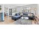 Open living room features a comfortable sectional sofa, modern lighting, and large windows for ample natural light at 6680 E Mississippi Ave # 3, Denver, CO 80224
