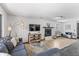 Bright living room featuring a cozy fireplace, comfortable seating, and modern lighting at 6680 E Mississippi Ave # 3, Denver, CO 80224