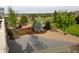 Wide-open backyard view featuring mature landscaping, small trees, and a stone patio at 7635 Weaver Cir, Castle Rock, CO 80104