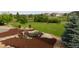 Beautifully landscaped backyard featuring plush lawn, trees, rocks and mulch at 7635 Weaver Cir, Castle Rock, CO 80104