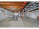 Unfinished basement featuring a ping pong table, exposed ceiling, and utility infrastructure at 7635 Weaver Cir, Castle Rock, CO 80104