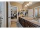Elegant bathroom featuring double sinks, granite countertops, and warm lighting at 7635 Weaver Cir, Castle Rock, CO 80104